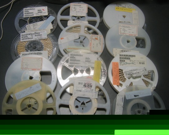 Lot of 12 reels of mixed quantity capacitors