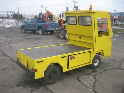 Cushman electric utility cart with flatbed full cab