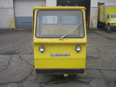 Cushman electric utility cart with flatbed full cab