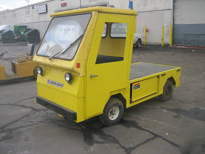 Cushman electric utility cart with flatbed full cab